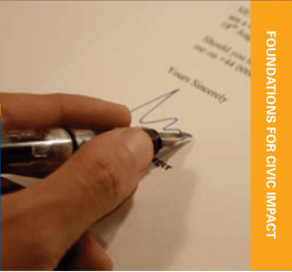 hand holding pen signing letter with yellow text bar running down side that reads FOUNDATIONS FOR CIVIC IMPACT